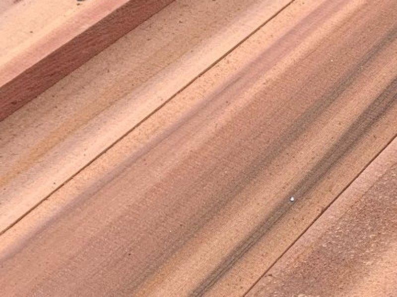 Stacked rough cut cedar boards