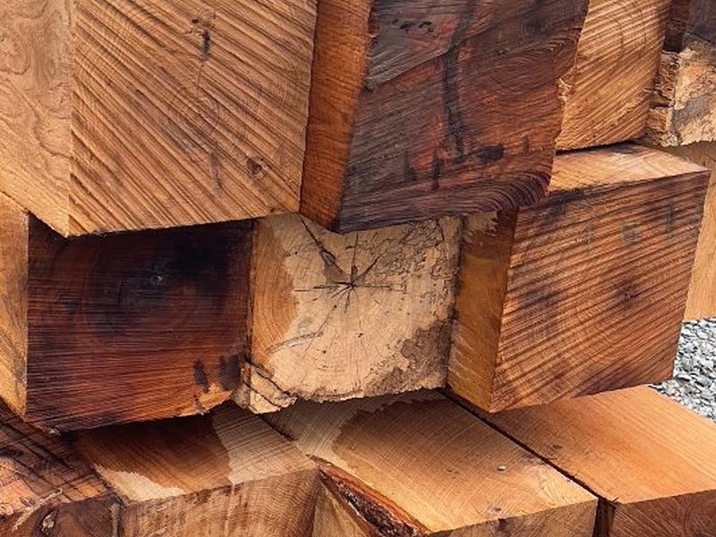 Heavy weathered timber beams stacked