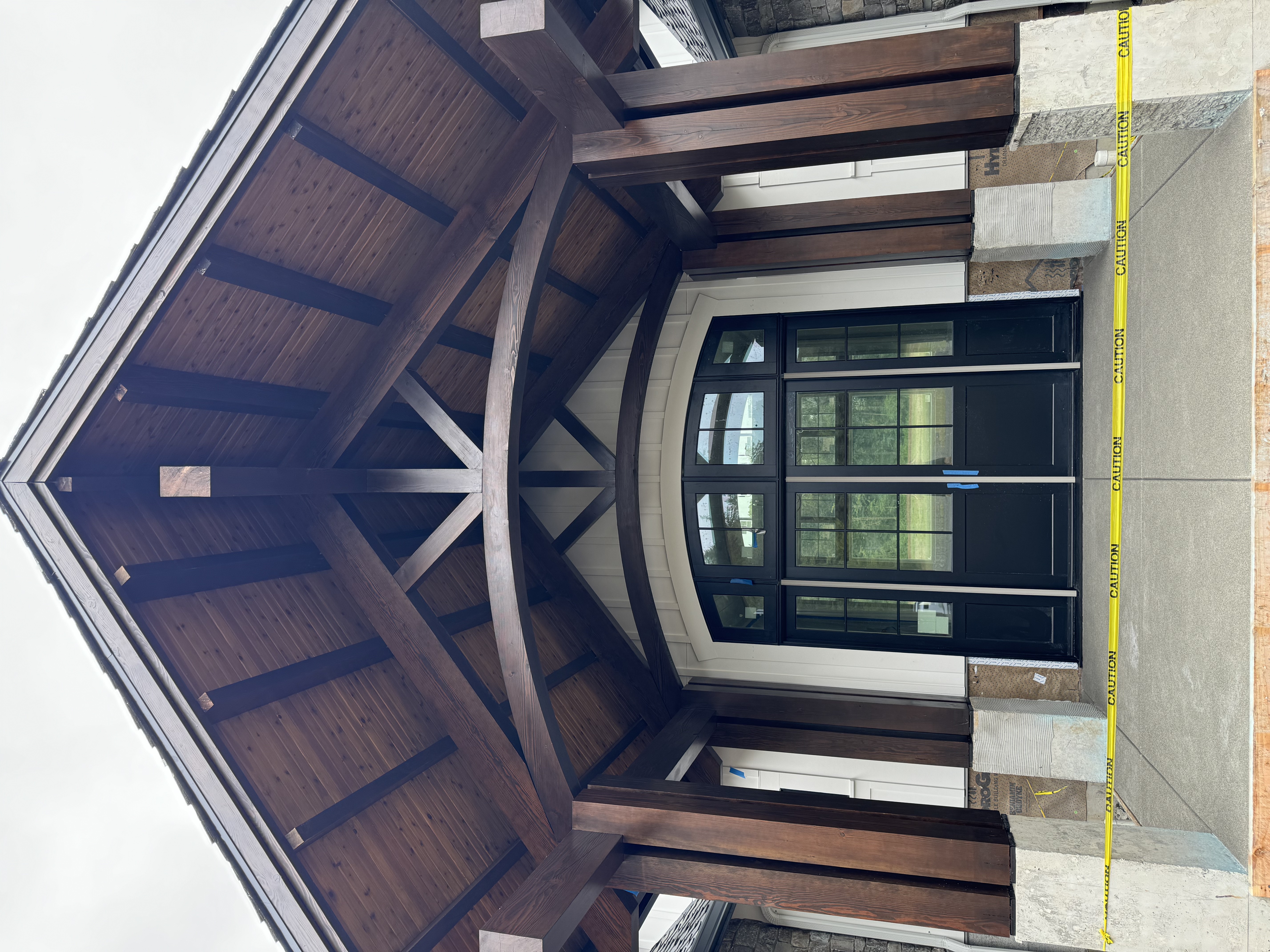 Dark stained timber gable entry portico on residential build