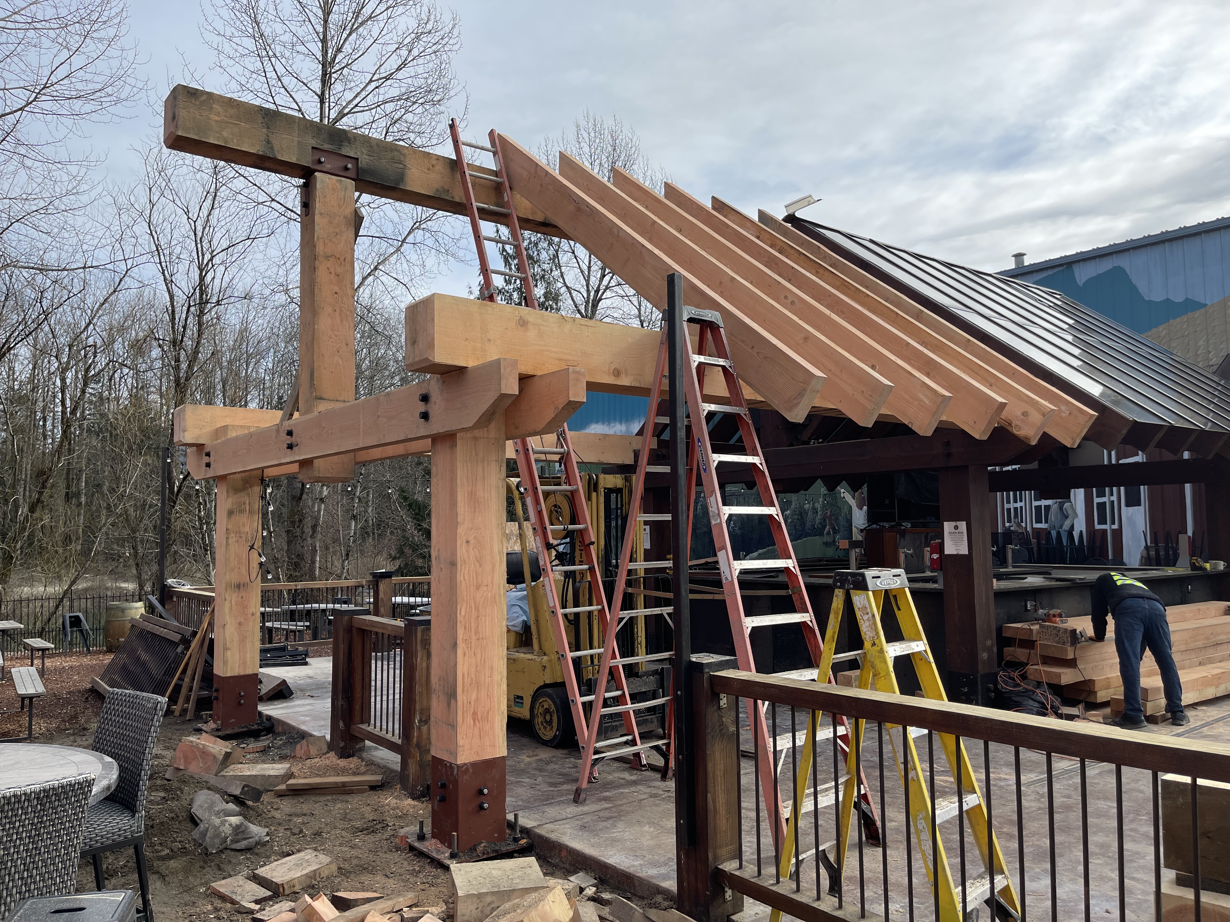 Outdoor timber pavilion under construction with heavy Douglas Fir framing
